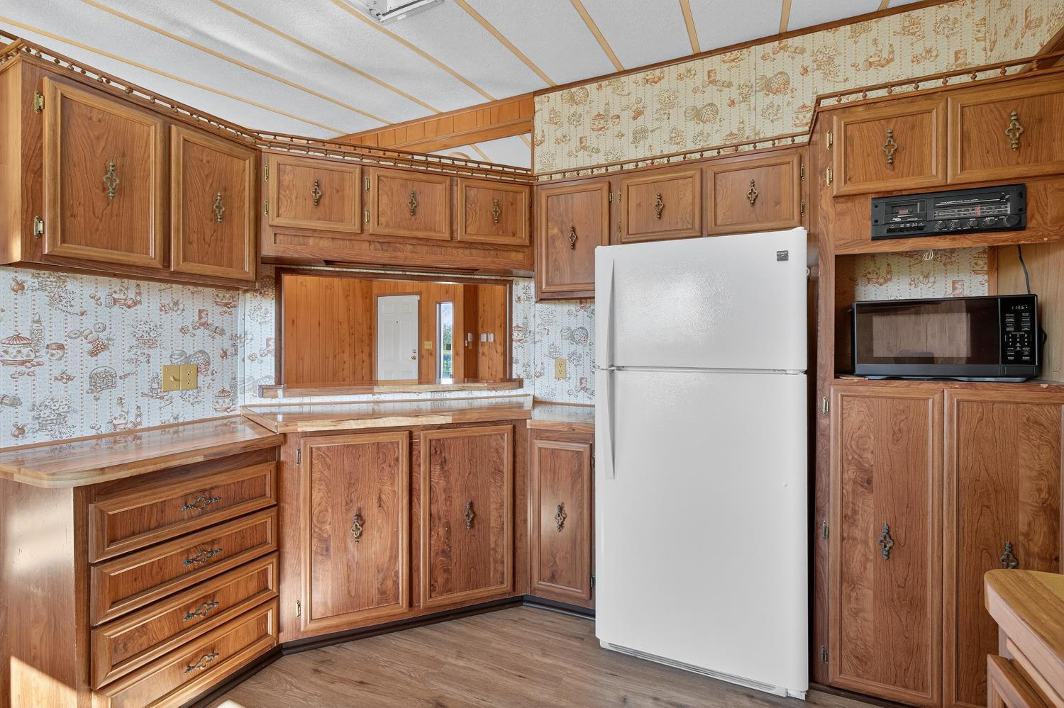 11900 Brandt Road Lockeford, CA 95237 - Photo 20 of 49 a white refrigerator freezer sitting inside of a kitchen