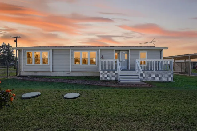a view of backyard with a garden and deck