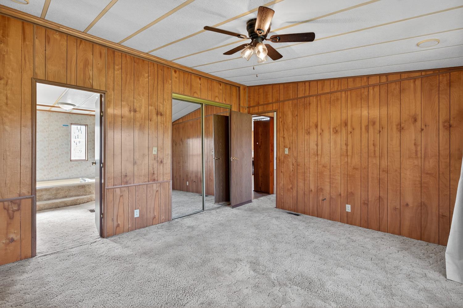 11900 Brandt Road Lockeford, CA 95237 - Photo 22 of 49 a view of a livingroom with a chandelier fan and closet area