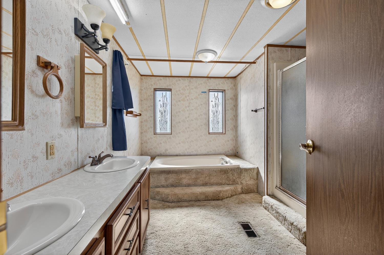 11900 Brandt Road Lockeford, CA 95237 - Photo 23 of 49 a en suite bathroom with a granite countertop sink and a mirror