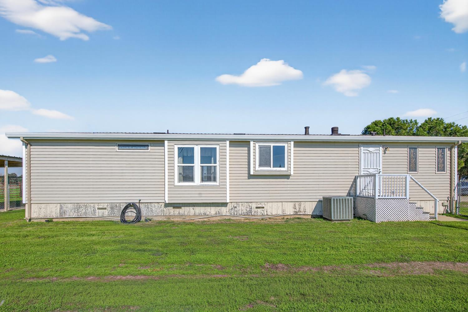 11900 Brandt Road Lockeford, CA 95237 - Photo 3 of 49 a front view of a house with a garden