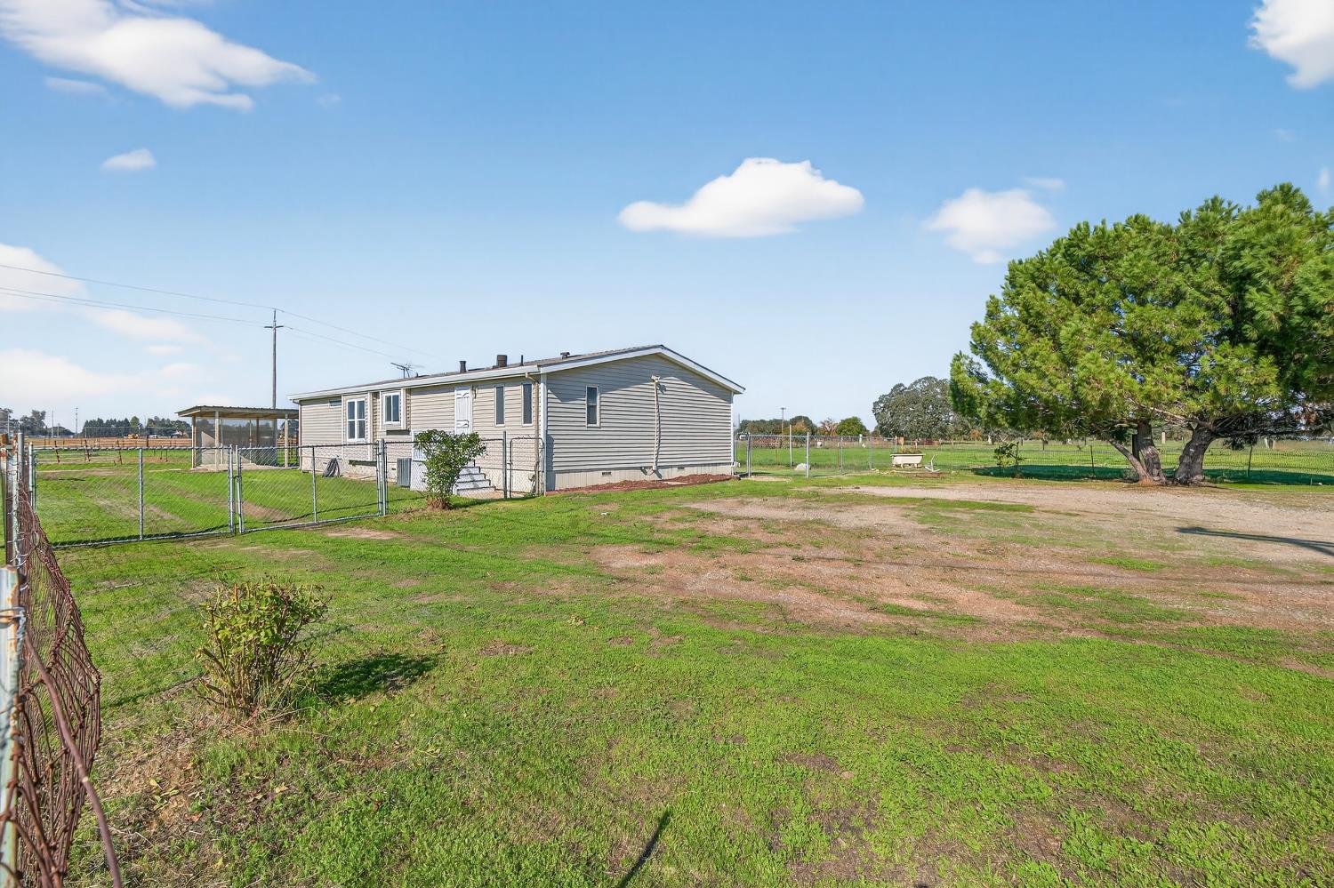 11900 Brandt Road Lockeford, CA 95237 - Photo 4 of 49 a view of a house with a big yard