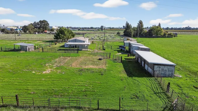 a view of an house with backyard space and sitting area