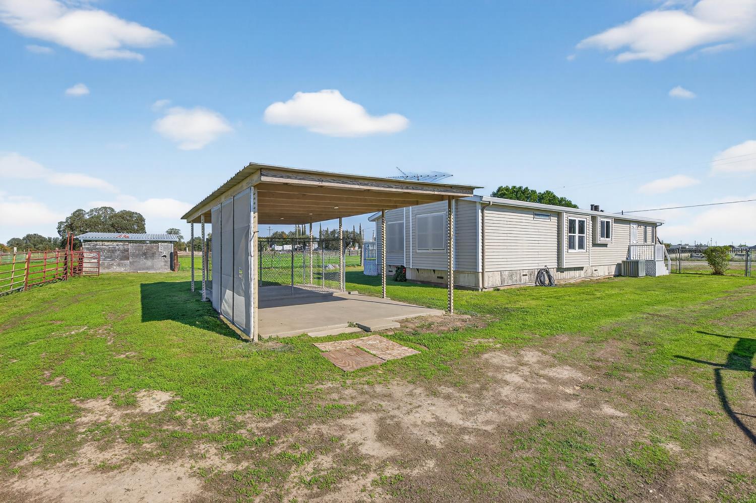 11900 Brandt Road Lockeford, CA 95237 - Photo 47 of 49 a view of an house with backyard porch and garden