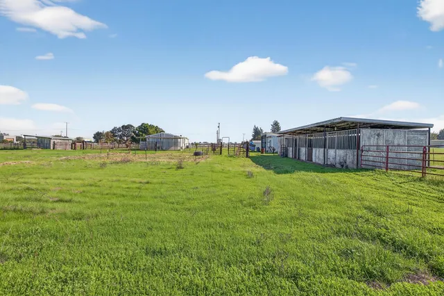 a view of a house with a backyard and a kitchen
