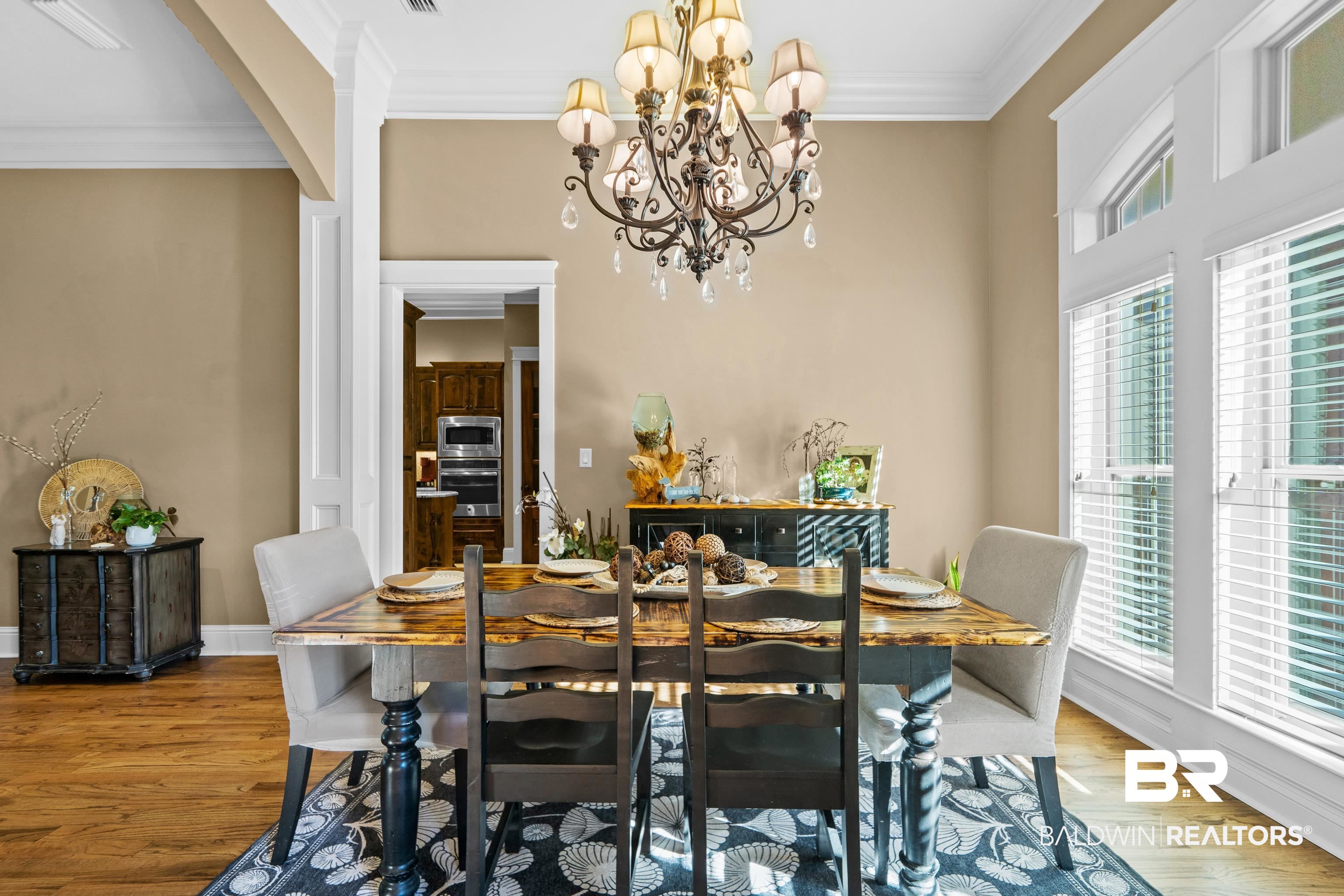 31829 Butler Drive Daphne, AL 36527 - Photo 14 of 48 Dining space with ornamental molding, a notable chandelier, light hardwood / wood-style floors, and a healthy amount of sunlight