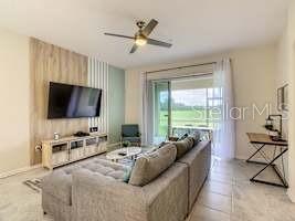 707 Ocean Course Avenue Davenport, FL 33896 - Photo 1 of 31 a living room with furniture and a flat screen tv
