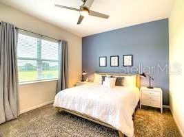 707 Ocean Course Avenue Davenport, FL 33896 - Photo 12 of 31 a bedroom with a large bed and a window