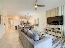 707 Ocean Course Avenue Davenport, FL 33896 - Photo 16 of 31 a living room with furniture and a flat screen tv