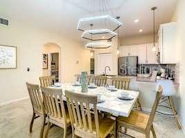 707 Ocean Course Avenue Davenport, FL 33896 - Photo 18 of 31 a dining room with furniture and wooden floor