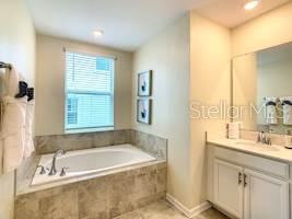 707 Ocean Course Avenue Davenport, FL 33896 - Photo 19 of 31 a bathroom with a tub a sink and a window