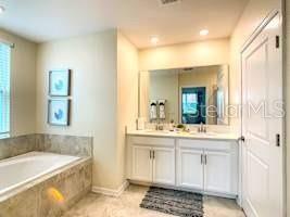 707 Ocean Course Avenue Davenport, FL 33896 - Photo 22 of 31 a bath room with a sink and a mirror