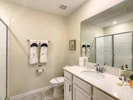 707 Ocean Course Avenue Davenport, FL 33896 - Photo 24 of 31 a bathroom with a sink toilet and shower