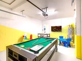 707 Ocean Course Avenue Davenport, FL 33896 - Photo 28 of 31 a living room with flat screen tv and kitchen view