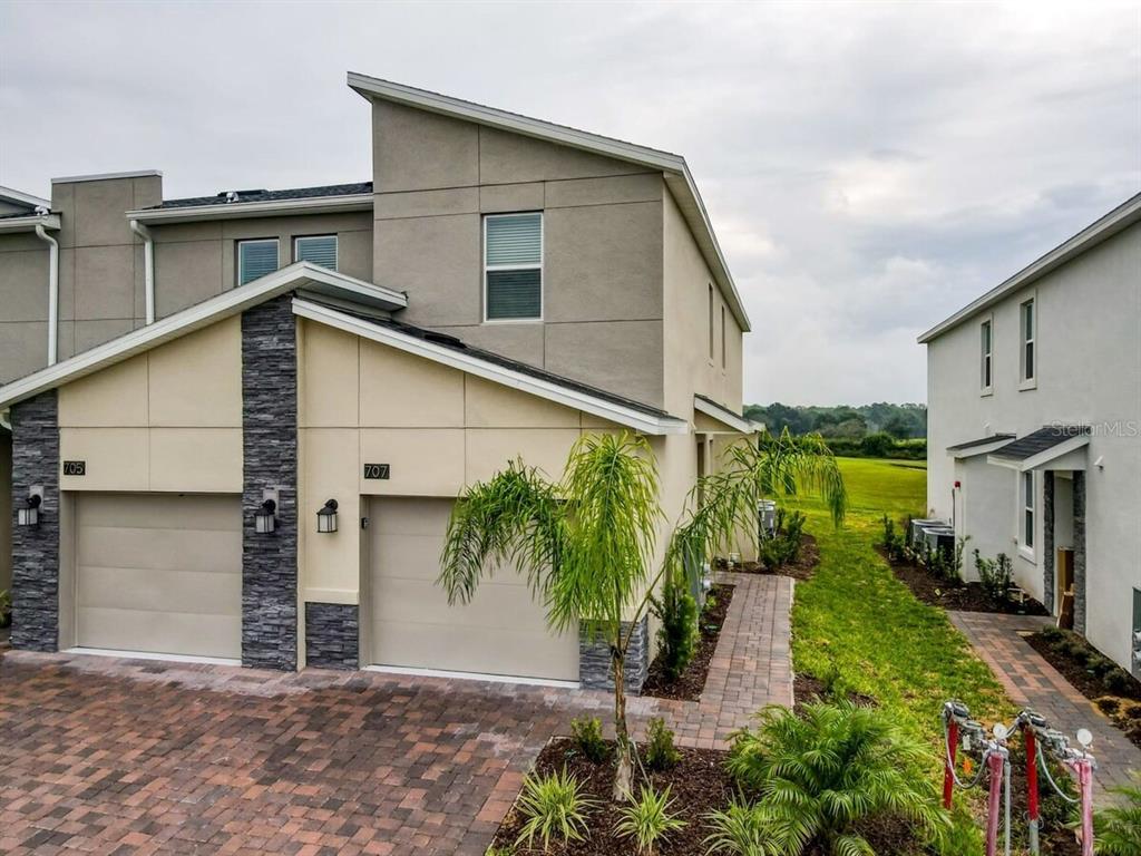 707 Ocean Course Avenue Davenport, FL 33896 - Photo 30 of 31 a front view of a house with garden