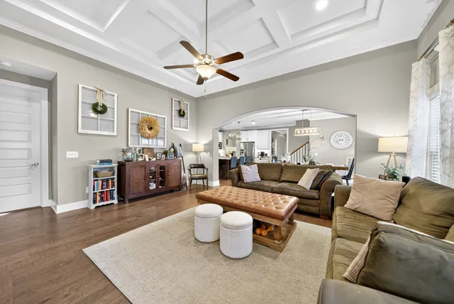 a living room with furniture and a chandelier
