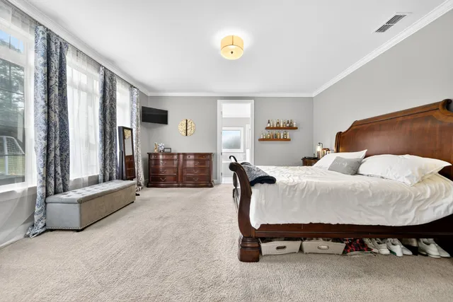 a spacious bedroom with a bed and window