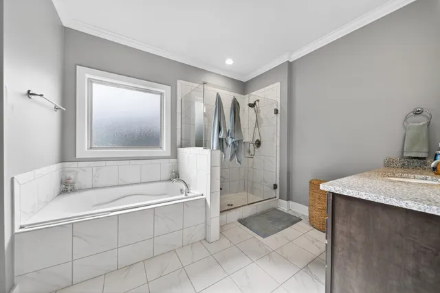 a bathroom with a tub a sink and mirror