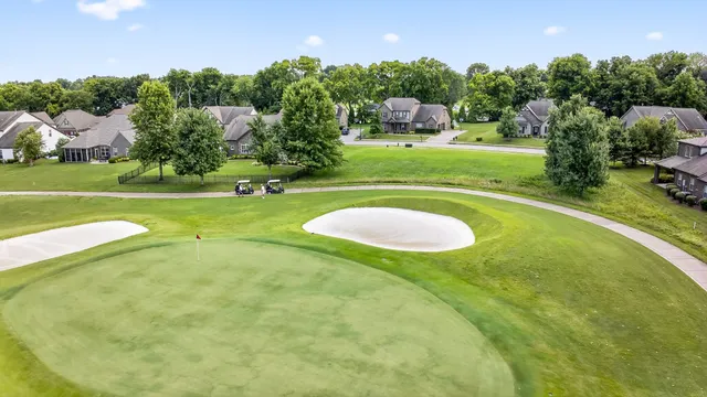 a swimming pool with outdoor seating and yard
