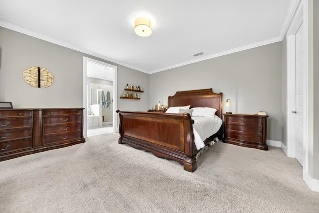 a bedroom with a bed and dresser