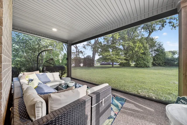 a view of yard from deck with patio
