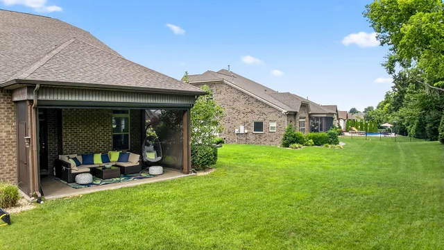 a view of a house with a backyard porch and sitting area