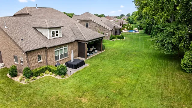 an aerial view of a house with garden space and street view