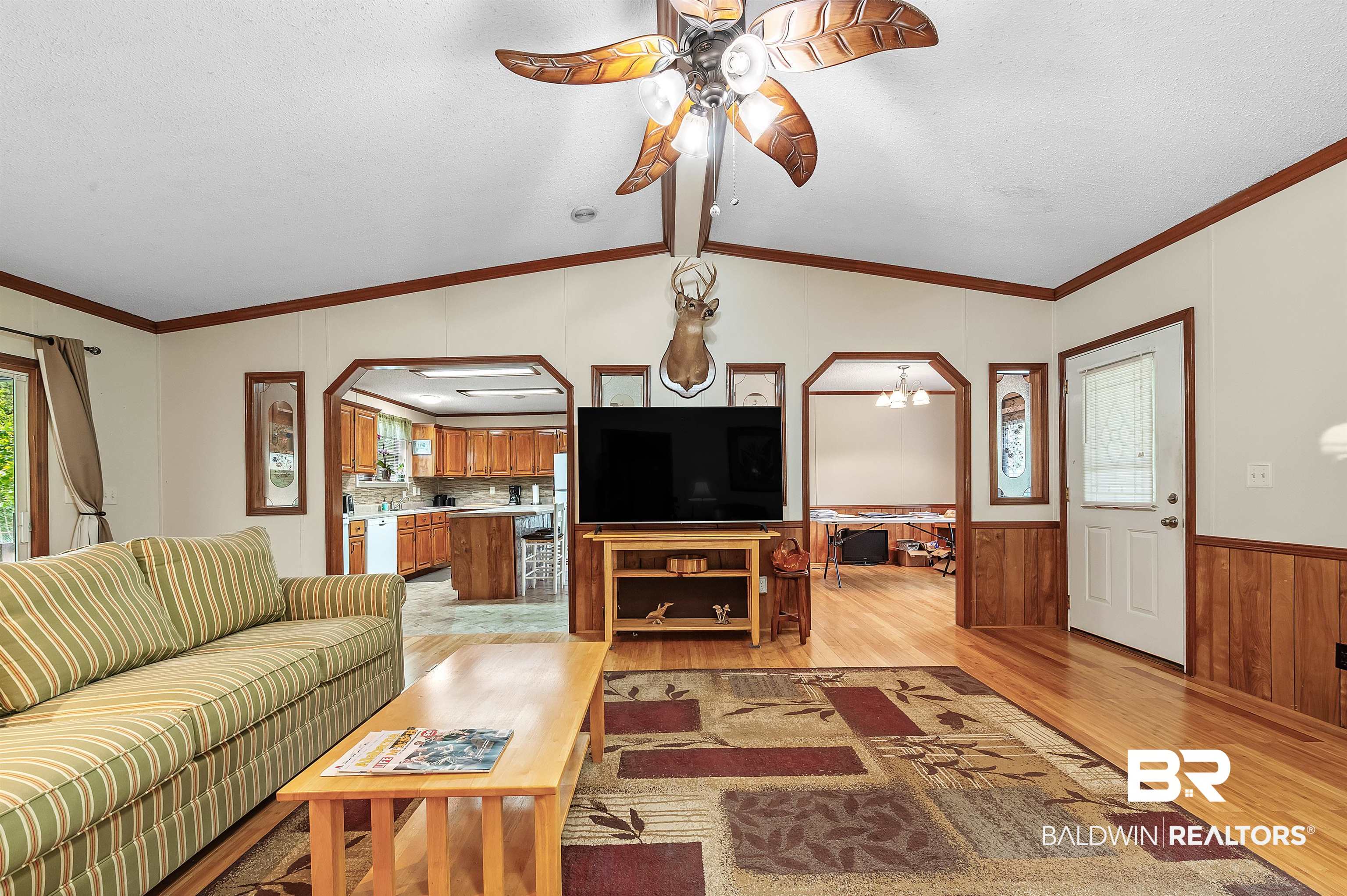 10970 Stucki Road Elberta, AL 36530 - Photo 18 of 56 Living room featuring Bamboo floors, vaulted ceiling, crown molding, and ceiling fan