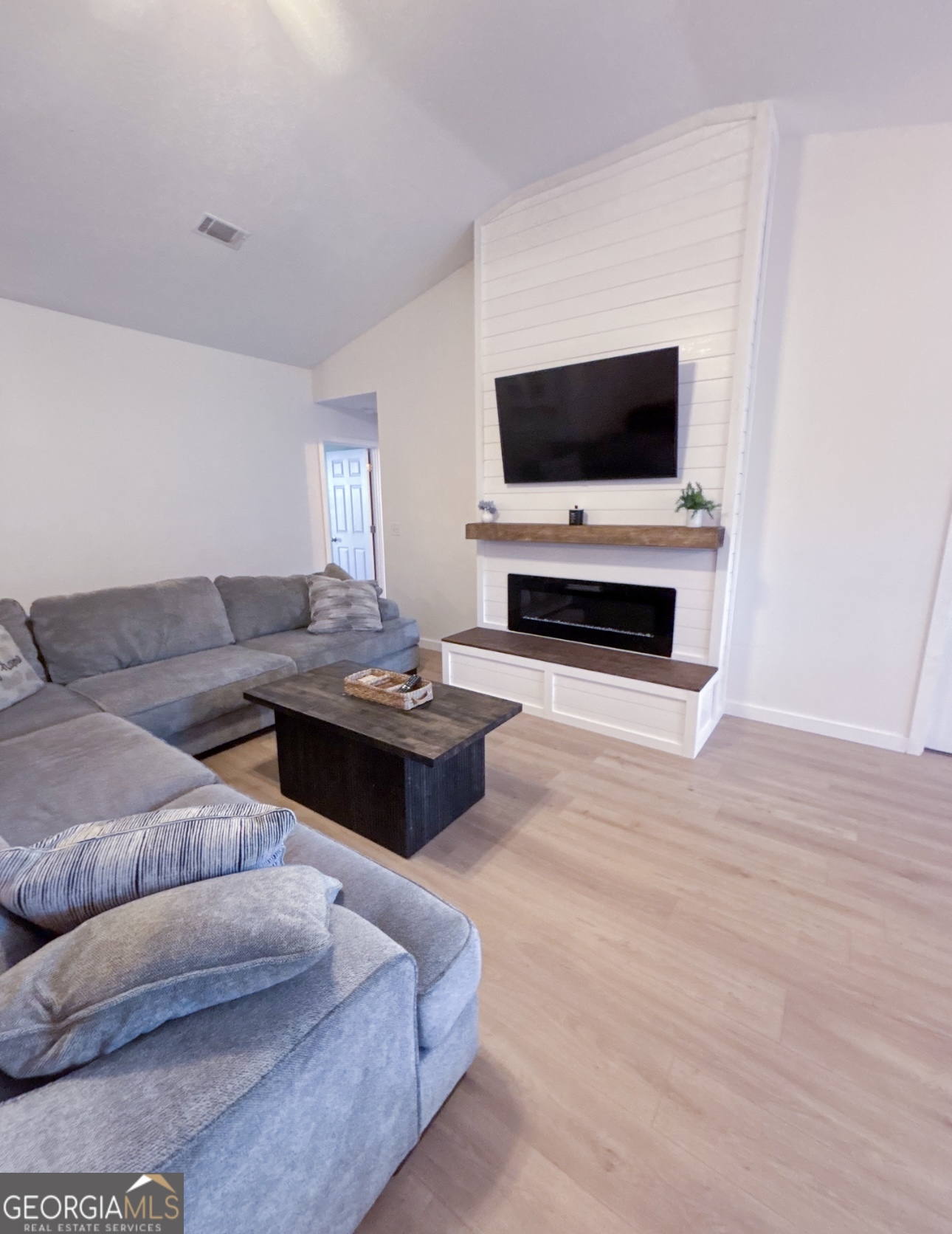 102 Honeysuckle Road Kingsland, GA 31548 - Photo 3 of 17 a living room with furniture and a flat screen tv