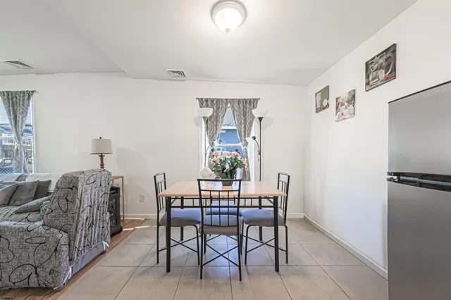 a dining room with furniture and a window
