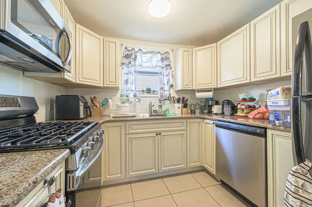 a kitchen with stainless steel appliances granite countertop a stove a sink and cabinets