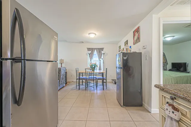 a kitchen with stainless steel appliances a refrigerator and a stove top oven
