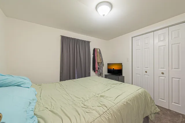 a large bed sitting in a bedroom and closet