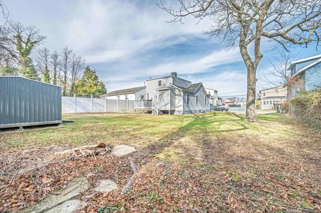 a view of a house with a yard and sitting area