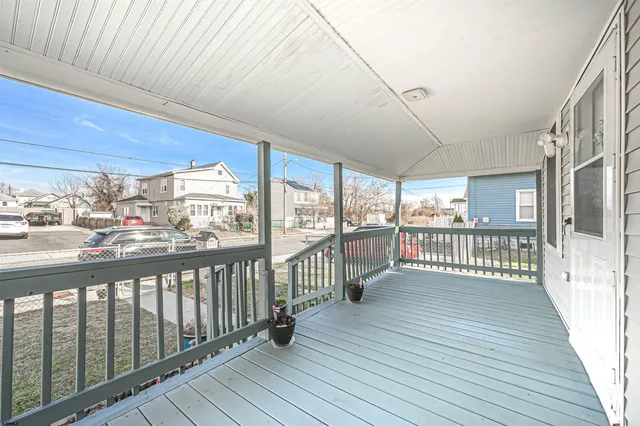 a view of a balcony with wooden floor