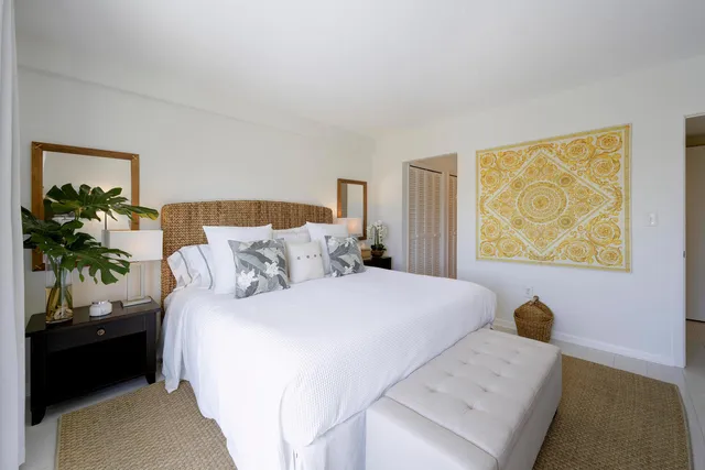 a bedroom with a bed and a painting on the wall