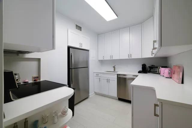 a kitchen with a sink a stove and refrigerator