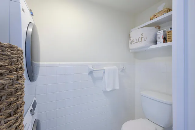 a bathroom with a toilet and a shower curtain