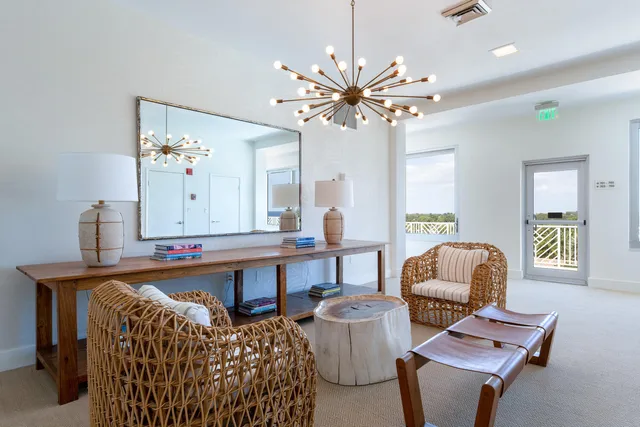 a living room with furniture a table and chair