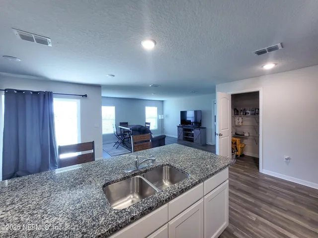 a spacious bedroom with a bed and a window