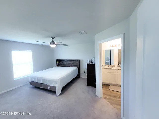 a bathroom with a granite countertop shower a sink and a mirror