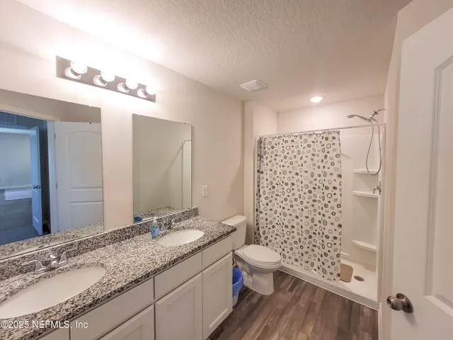 a view of a hallway with closet and wooden floor