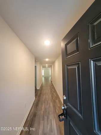 a bathroom with a granite countertop sink a toilet a mirror and shower curtain