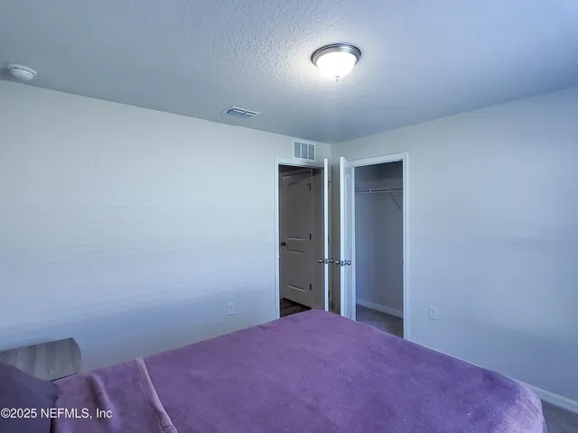 a kitchen with granite countertop a refrigerator and a sink