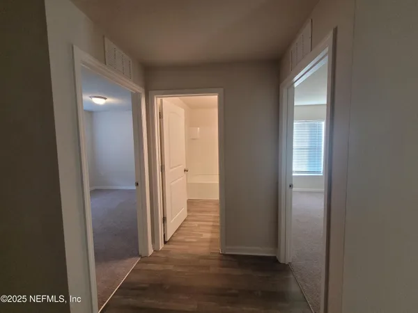 a view of hallway with wooden floor