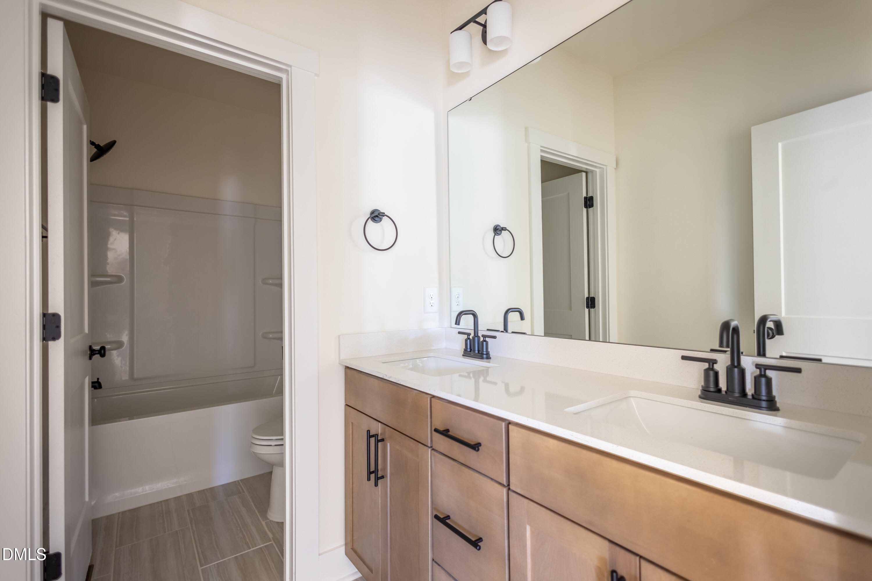 2001 Skipping Stone Drive Durham, NC 27705 - Photo 14 of 44 a bathroom with a sink and a mirror with bathtub