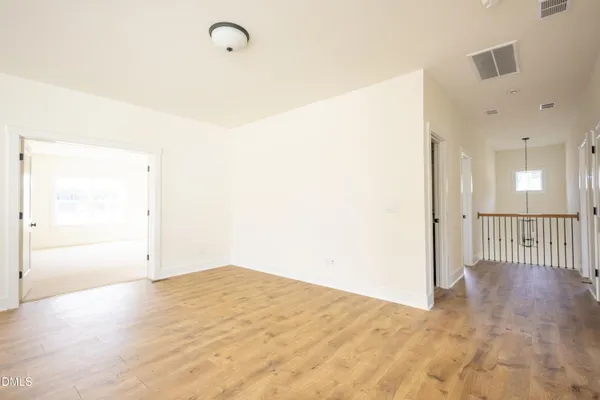 a view of a room with wooden floor