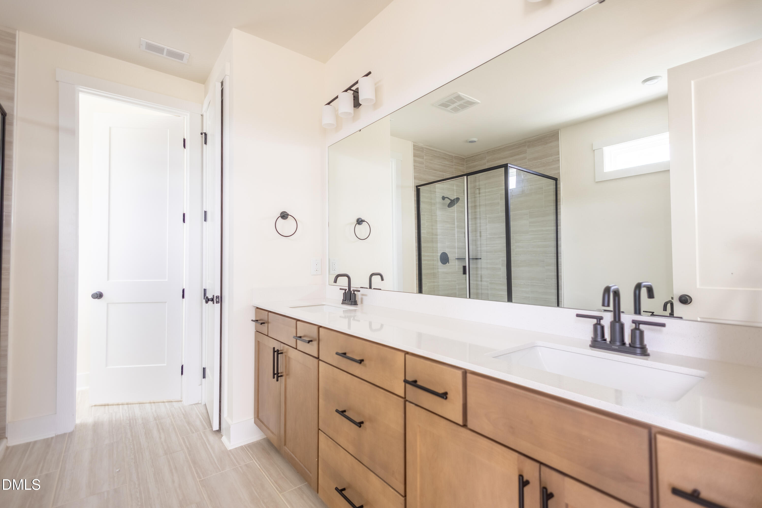 2001 Skipping Stone Drive Durham, NC 27705 - Photo 22 of 44 a bathroom with a sink double vanity granite tub shower and a mirror