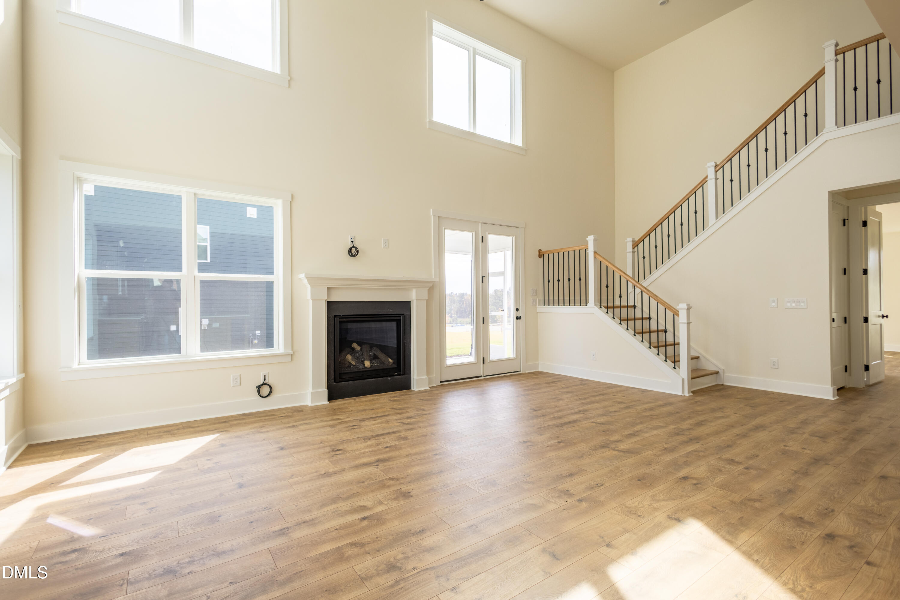 2001 Skipping Stone Drive Durham, NC 27705 - Photo 27 of 44 a view of an empty room with wooden floor fireplace and a window
