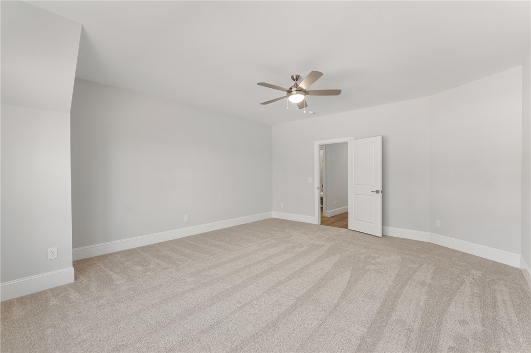 141 Rickys Path Easley, SC 29642 - Photo 32 of 40 This spacious bedroom offers ample comfort and versatility for personalization.